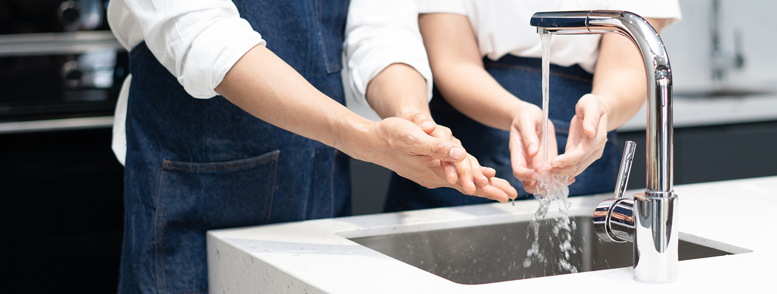 He washes his hands. Washing his hands thoroughly in a Sink. Glass Sink in hands.